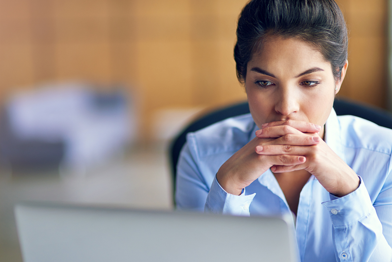 Women looking at a laptop deep in thought